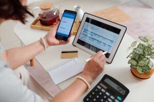 Couple reviewing retirement account statements and comparing Roth and Traditional IRA notes at a kitchen table.